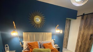 A bedroom with a bed, a nightstand, a wall-mounted lamp, and a wooden wardrobe. - Superb 1-bedroom apartment in vibrant Ciudad de México (Ciudad de México)