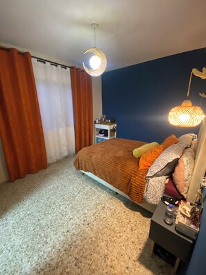 A bedroom with a bed, a nightstand, a dresser, and a hanging light fixture. - Superb 1-bedroom apartment in vibrant Ciudad de México (Ciudad de México)