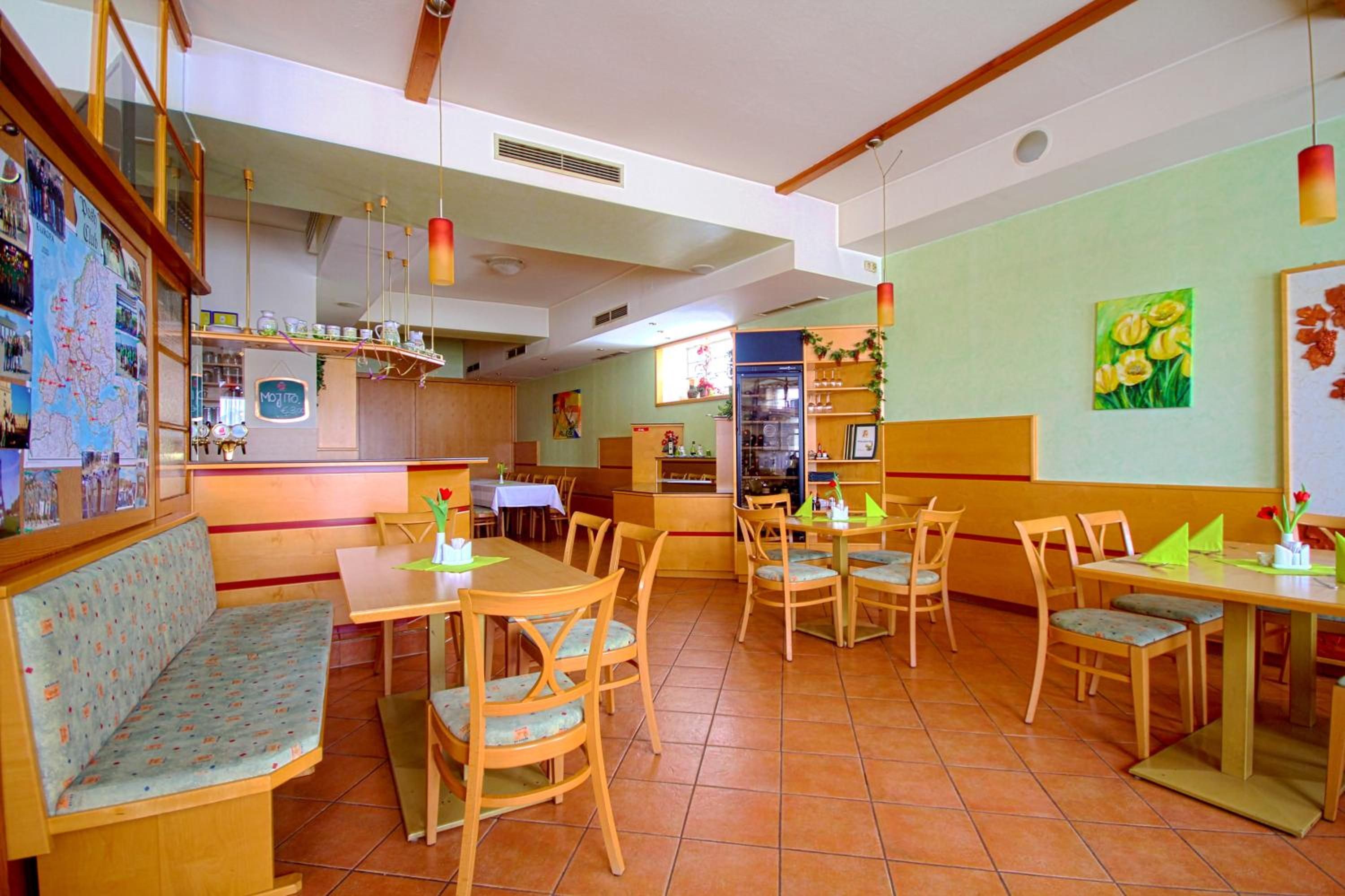 A restaurant with wooden furniture, a bar area, and a dining section.