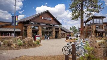A country store with a brick entrance, outdoor seating, and bicycles.