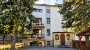 A multi-story building with a stone facade, a balcony, and a small entrance with a door. - For Rest Hostel (Lublin)