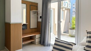 A modern bathroom with a wooden vanity, a mirror, and a shower area. - A more spacious family apartment with a full kitchen. (Azul)