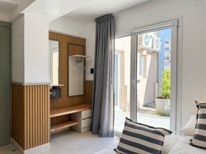 A modern bathroom with a wooden vanity, a mirror, and a shower area. - A more spacious family apartment with a full kitchen. (Azul)