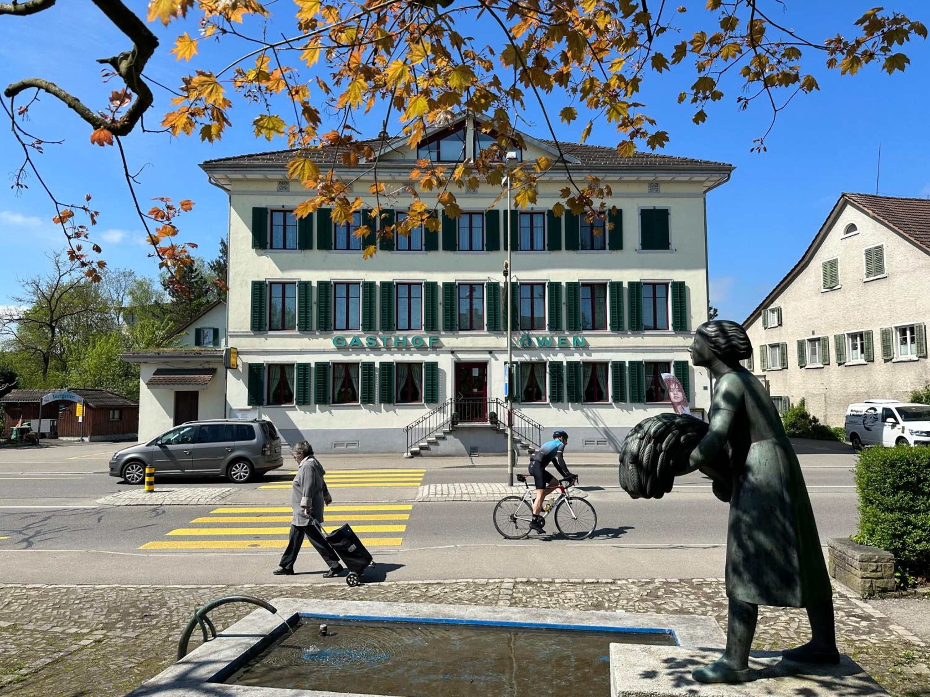 A building with a sign that reads 'GASTHOF' and 'AWEN' on the facade.