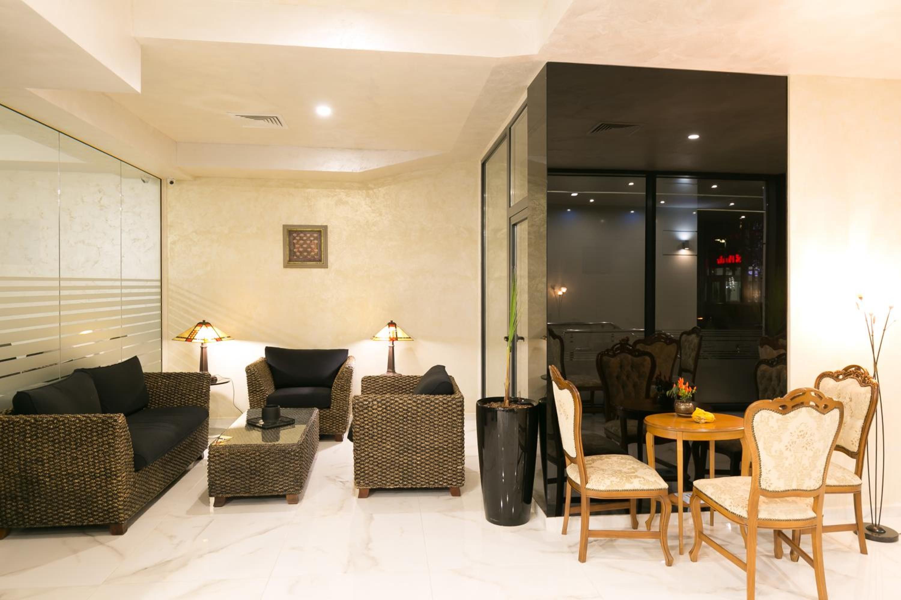 A modern living room with a sofa set, a coffee table, and a dining area with chairs.