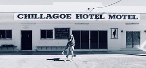 A building with a sign reading 'CHILLAGOE HOTEL MOTEL' and a chalkboard listing 'SPECIAL CHICKEN BURGER, BACON, EGG BURGER, LUNCH & DINNER.' - Chillagoe Cockatoo Hotel Motel (Chillagoe)