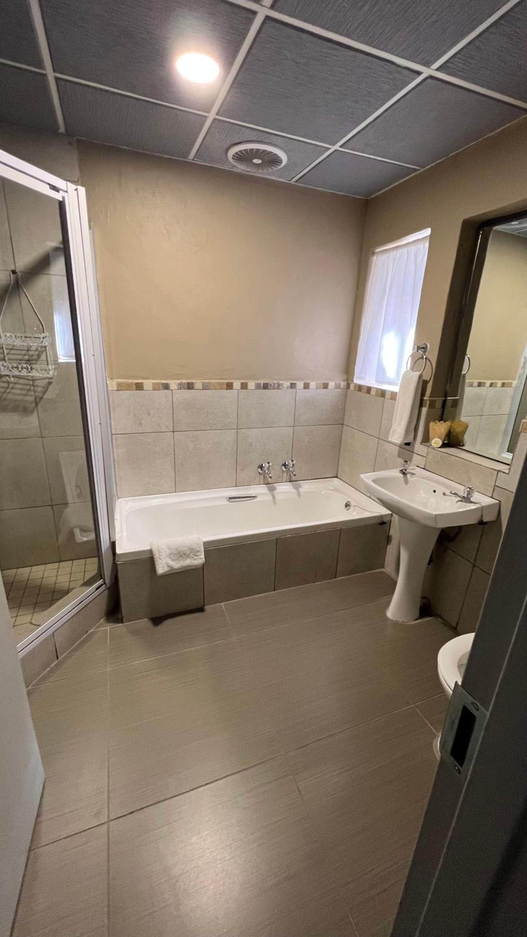 A bathroom with a bathtub, a sink, and a toilet.