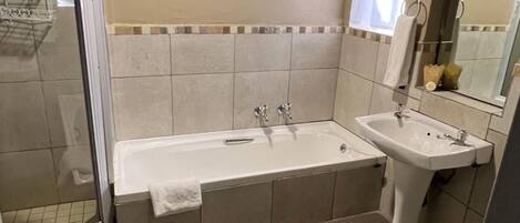 A bathroom with a bathtub, a sink, and a toilet.
