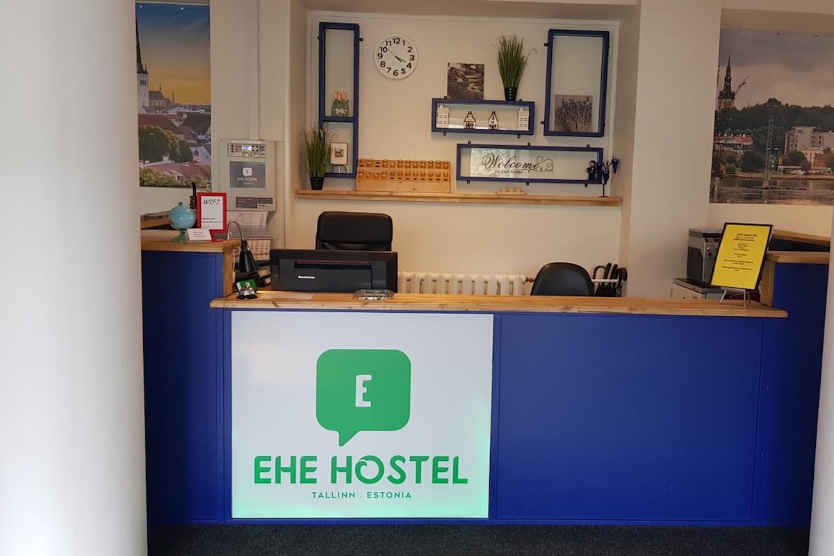 A reception desk with a sign for EHE HOSTEL in Tallinn, Estonia.
