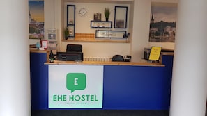 A reception desk with a sign for EHE HOSTEL in Tallinn, Estonia. - Ehe Hostel (Tallinn)