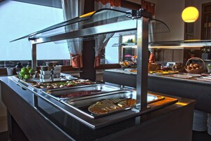 Un bufé con diferentes opciones de comida y una vitrina.