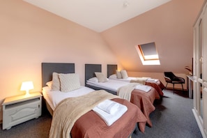 A hotel room with three beds, a desk, and a chair. - Butenas Hotel Tyla (Biržai)