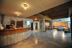 A spacious lobby with a reception desk, seating area, and a staircase leading to upper floors. - El Greco (Igoumenitsa)