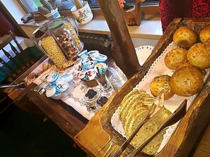 A table with various food items, including pastries and condiments. - Hotel Wolf (Selva di Val Gardena)