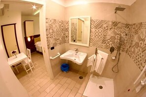 A bathroom with a sink, mirror, shower, and patterned walls. - Hotel Chic (Giugliano in Campania)
