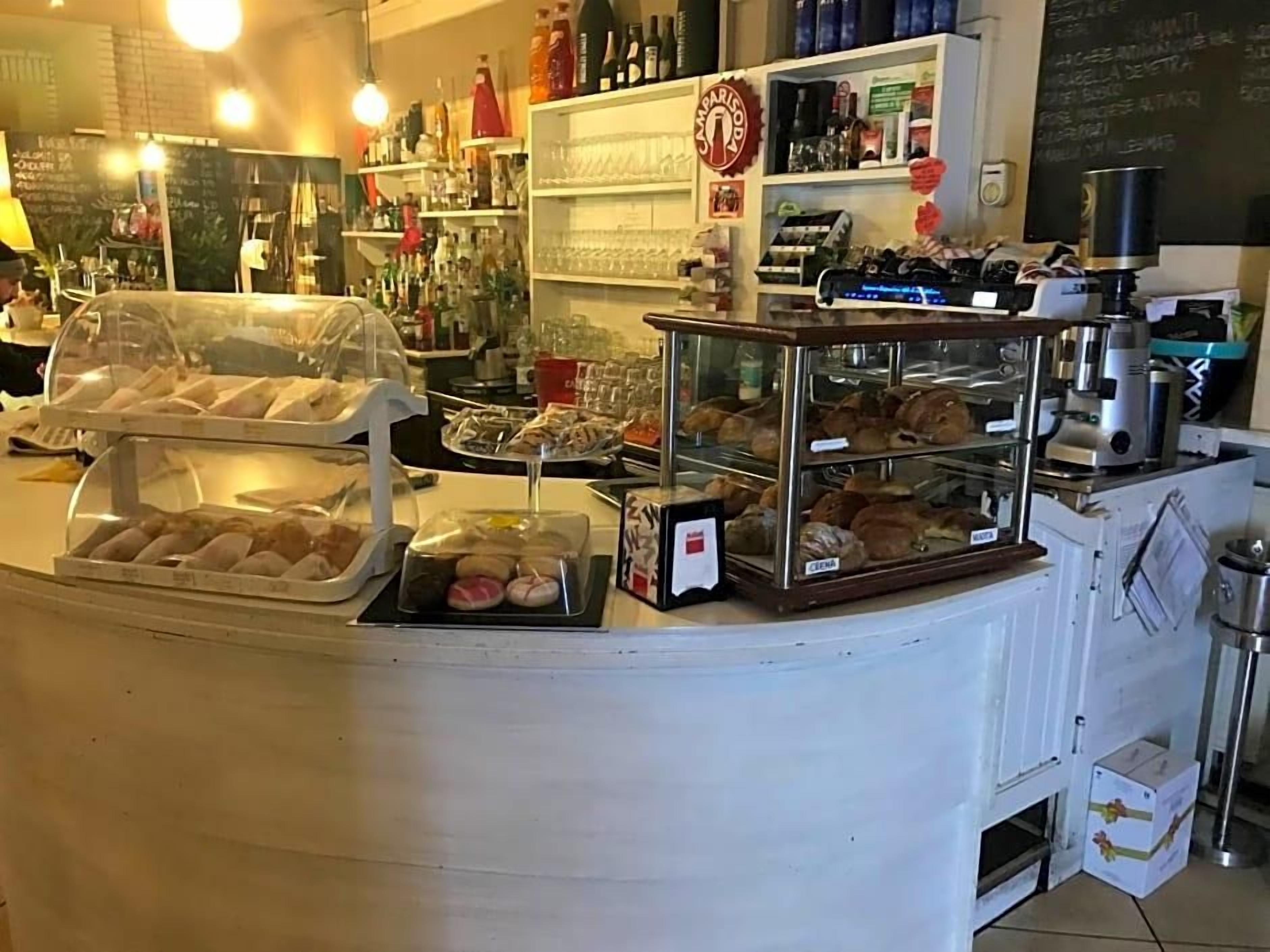 A bakery counter with various baked goods on display.