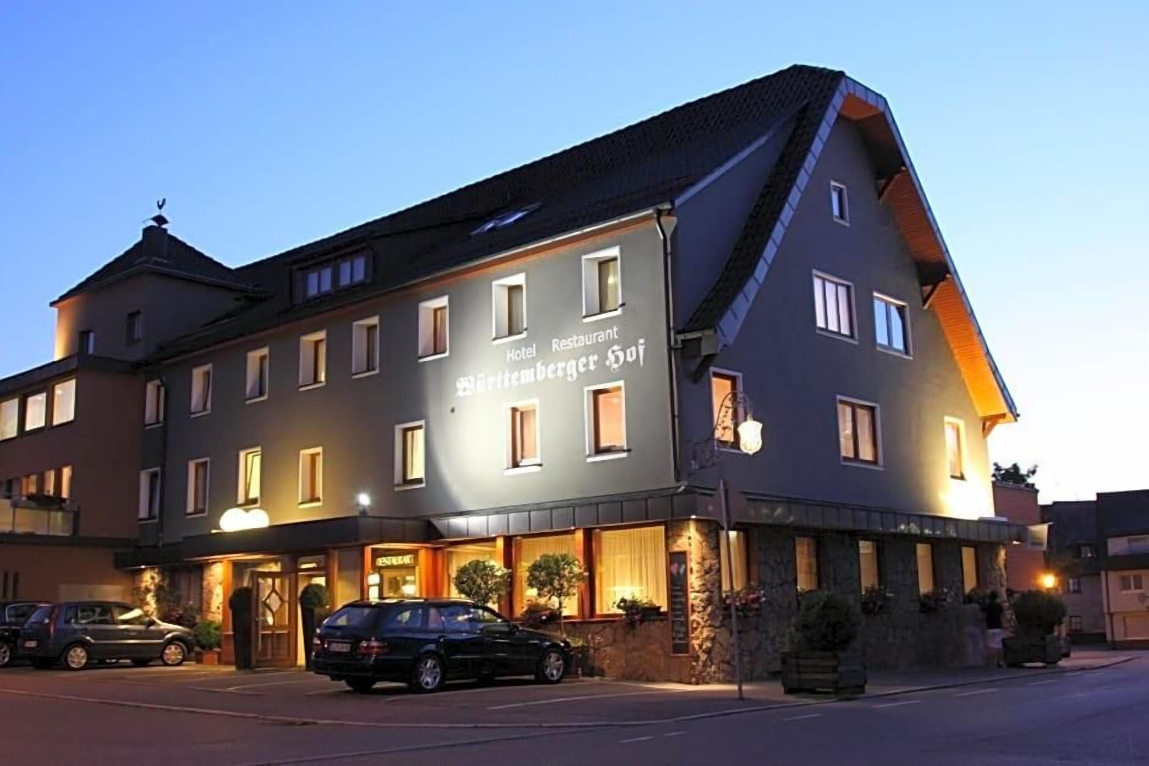 A hotel with a restaurant on the ground floor, multiple windows, and a stone facade.