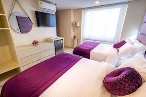 A hotel room with two beds, a TV, a mirror, a small desk, and a window. - Hotel Trugo (Armenia)