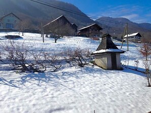 A snow-covered landscape with traditional houses and a small building with a sloped roof. - Hotel Le Lv Man (Saint-Gingolph)