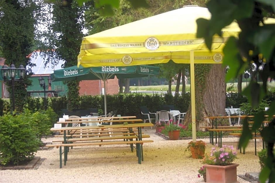Outdoor seating with umbrellas, a tree, and a building in the background.