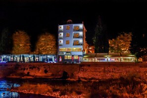 A multi-story building with a sign for 'Luxury Rooms & Restaurant CENTRAL' at night. - Central Guest Rooms (Asenovgrad)