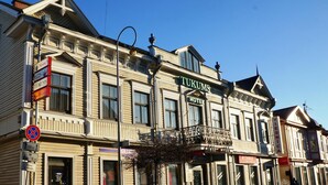 A historic building with a sign for 'TUKUMS HOTEL' and a 'VIESNICA' sign. - Hotel Tukums (Tukums)