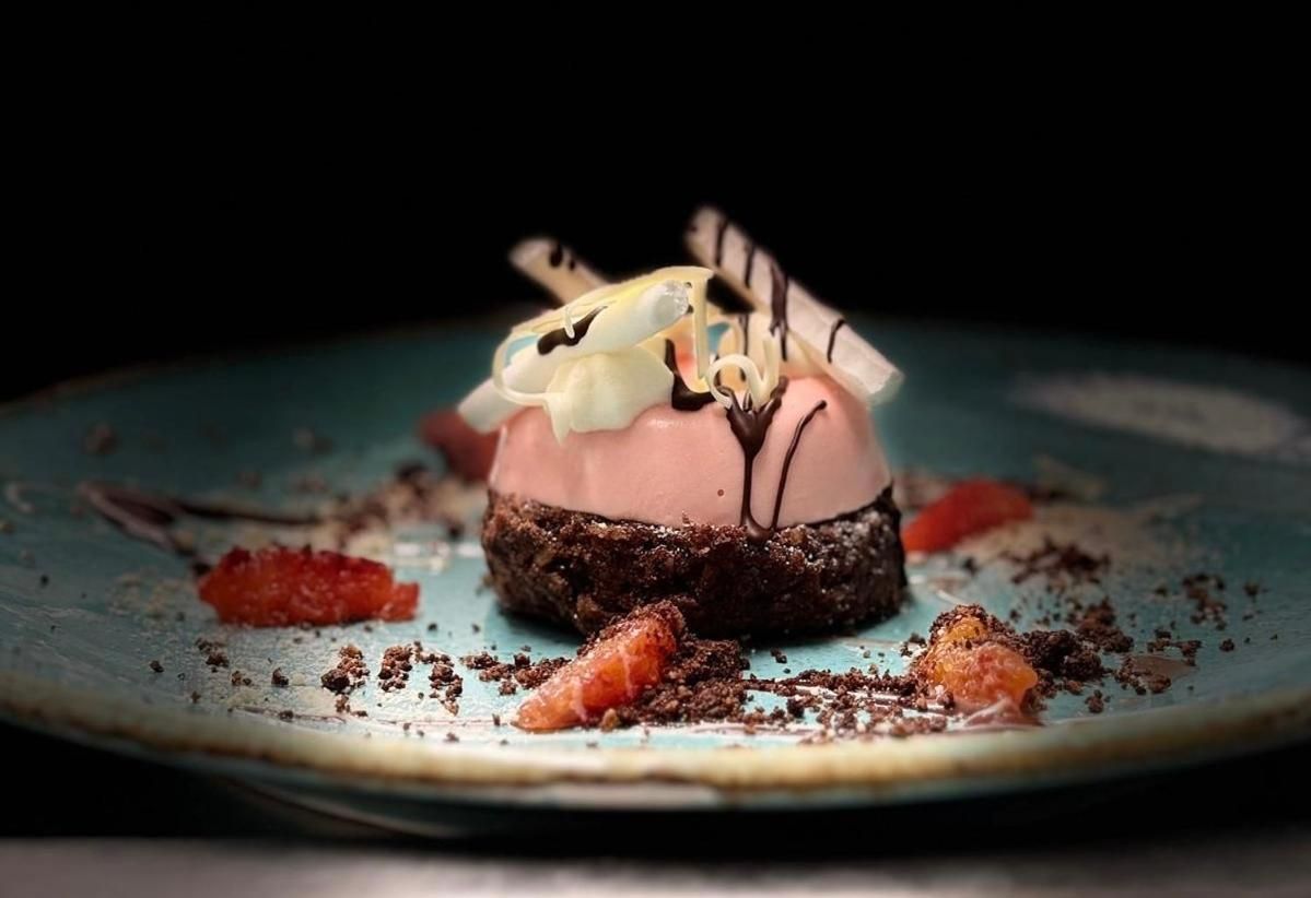 A dessert on a plate with a dark background.