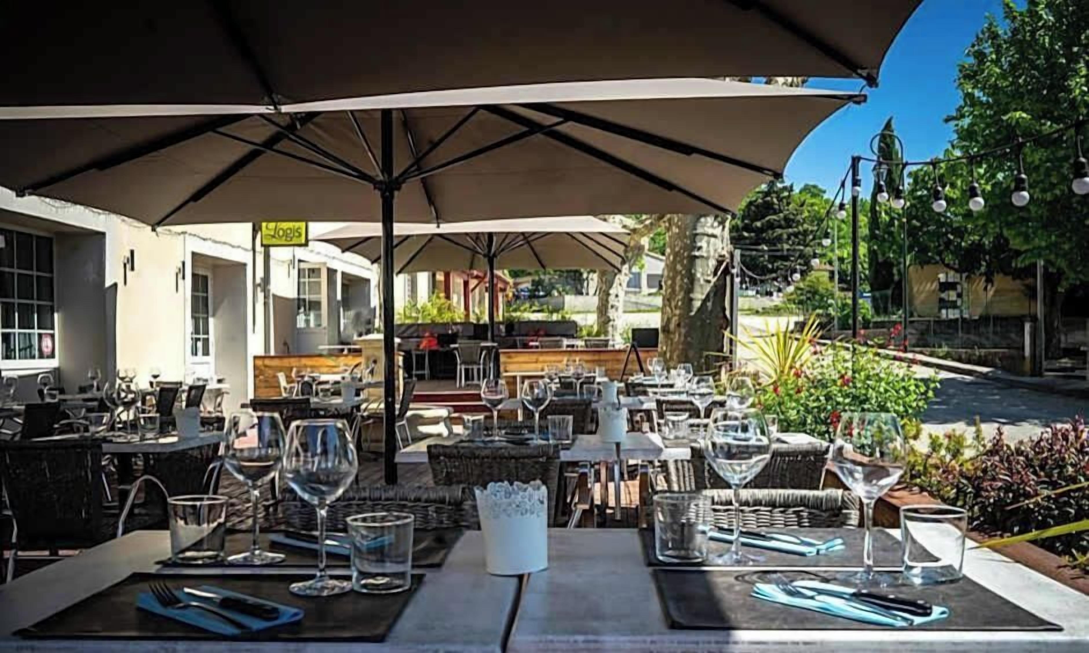 An outdoor dining area with tables, chairs, and umbrellas.