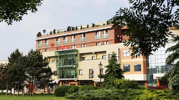 A hotel with a modern facade, multiple windows, and a prominent 'HOTEL' sign.