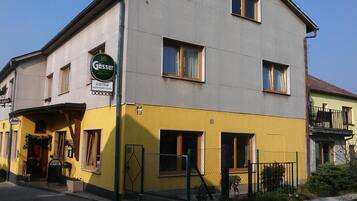 A two-story building with a sign for 'Gösser' and 'GRISTHOFF SCHWITZER ALTER' indicating a restaurant or inn.