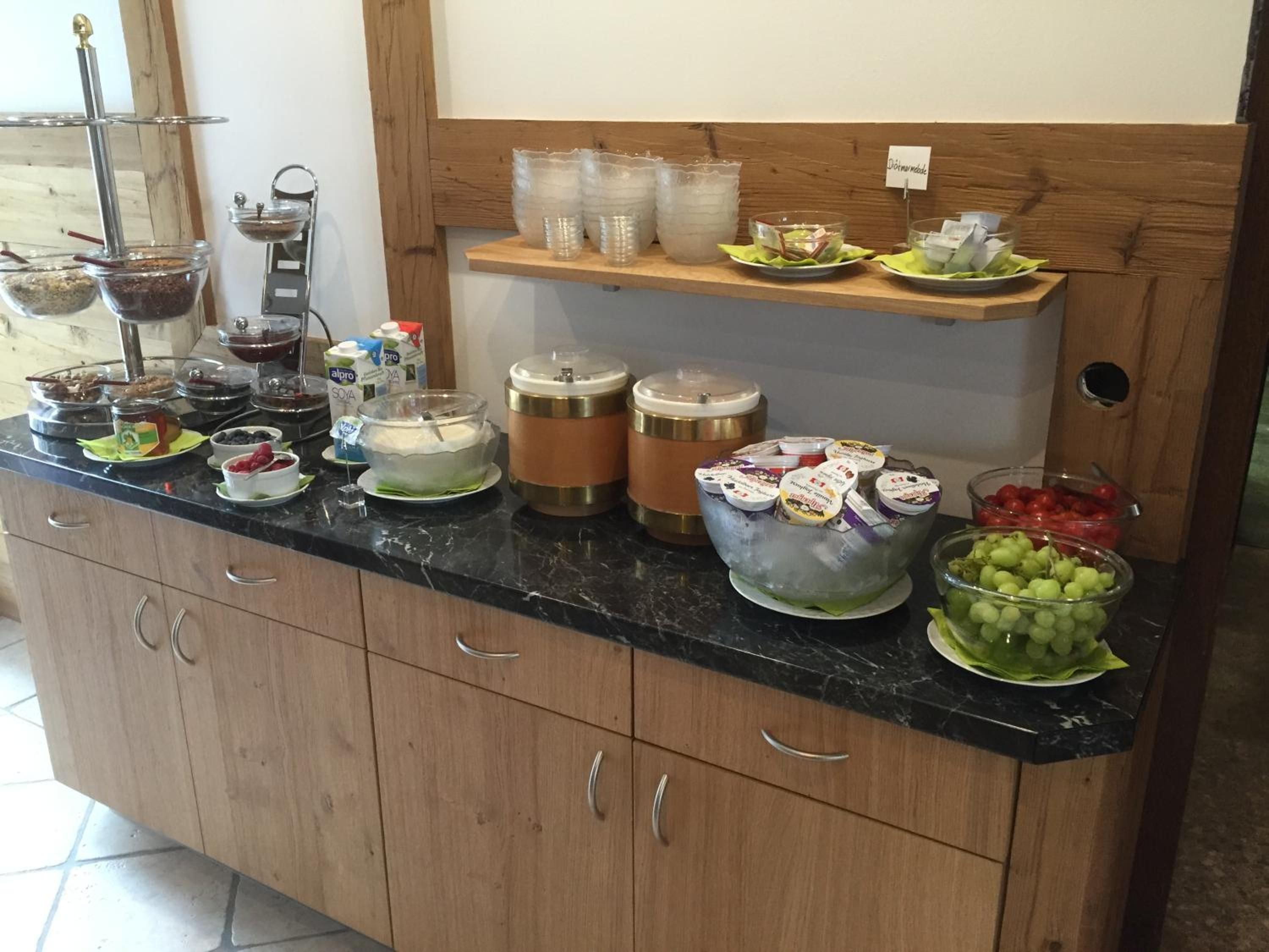 Una mesa de buffet con diversos alimentos y recipientes.
