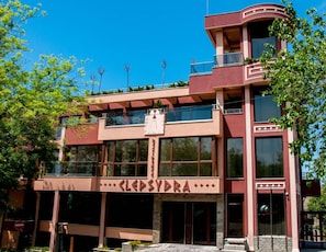 Un edificio de varios pisos con un letrero llamativo que dice 'CLEASYDRA'.