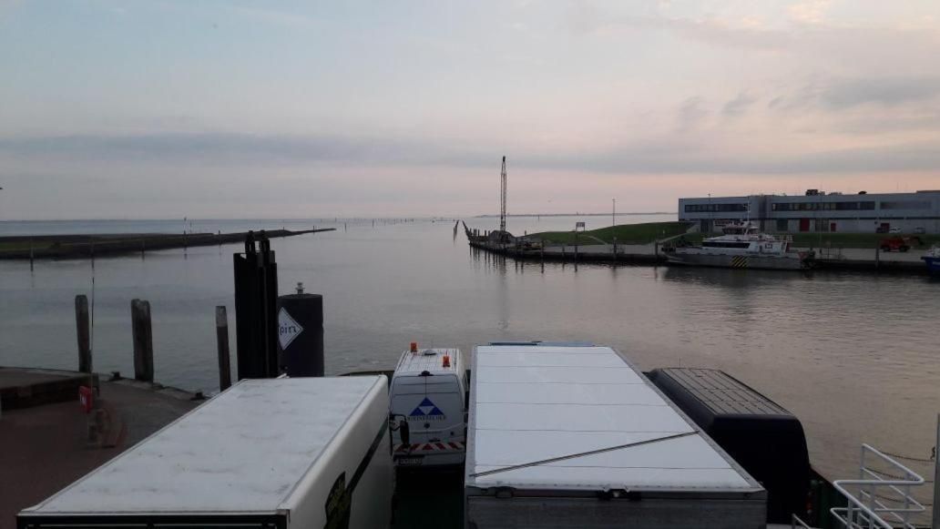 A waterfront view with a dock, a pier, and a building in the background.