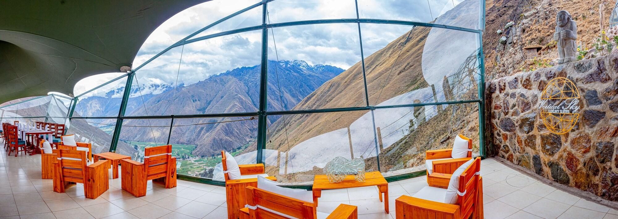 A restaurant with a view of mountains through large windows.