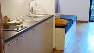 A modern kitchen with a built-in sink, cabinets, and a wooden countertop.