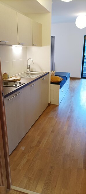 Une cuisine moderne dotée d’un évier encastré, de placards et d’un plan de travail en bois.