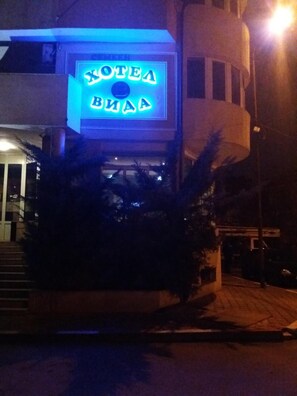A building with a neon sign that reads 'KOTEYA VILLA'.