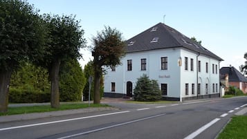 A two-story building with a sign reading 'Hotel Andel' on the facade.