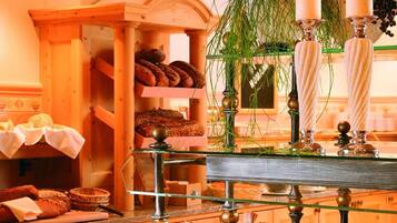 A buffet setup with various food items and a decorative plant.