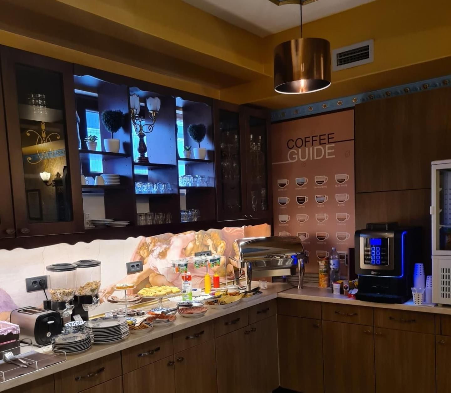 A coffee station with a coffee guide, a coffee machine, and various coffee-making accessories.