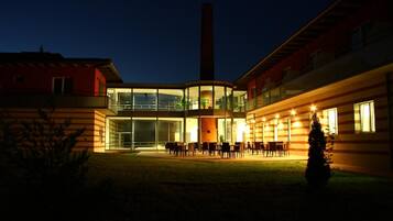 A building with a central courtyard, large windows, and a chimney.