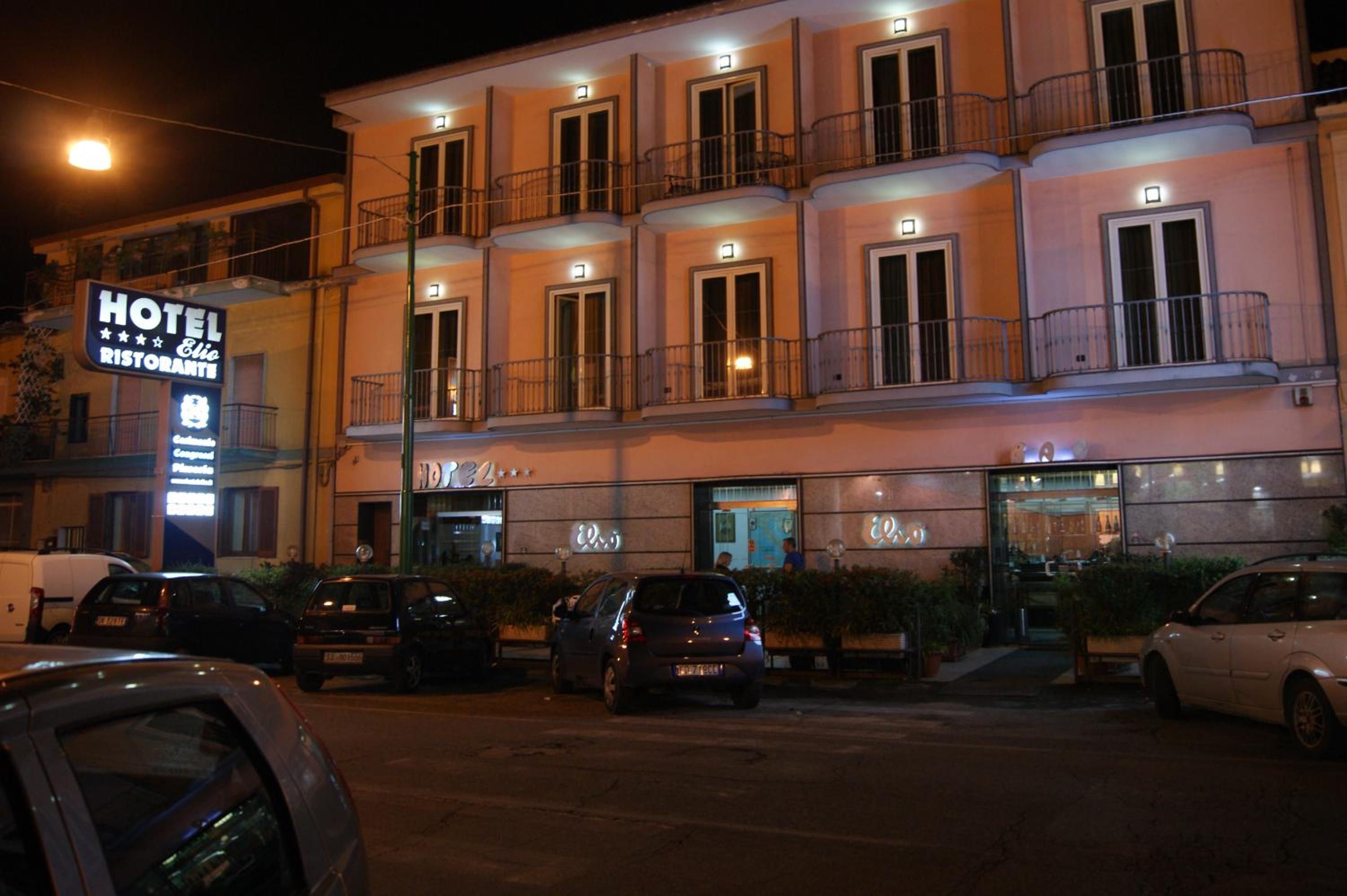 A hotel with multiple balconies and a sign indicating it is a restaurant.