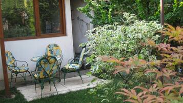 A patio with outdoor furniture and a garden.