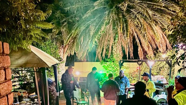 An outdoor patio area with a fire feature, seating, and a covered area with tables and chairs. - Bakery Park Motor Inn (Tocumwal)