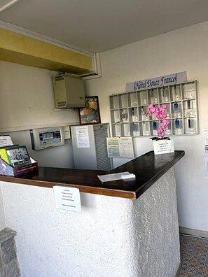 A reception desk with a sign reading 'Hotel Douce France'. - H¬øtel Restaurant Douce France (Saint Alban Auriolles)
