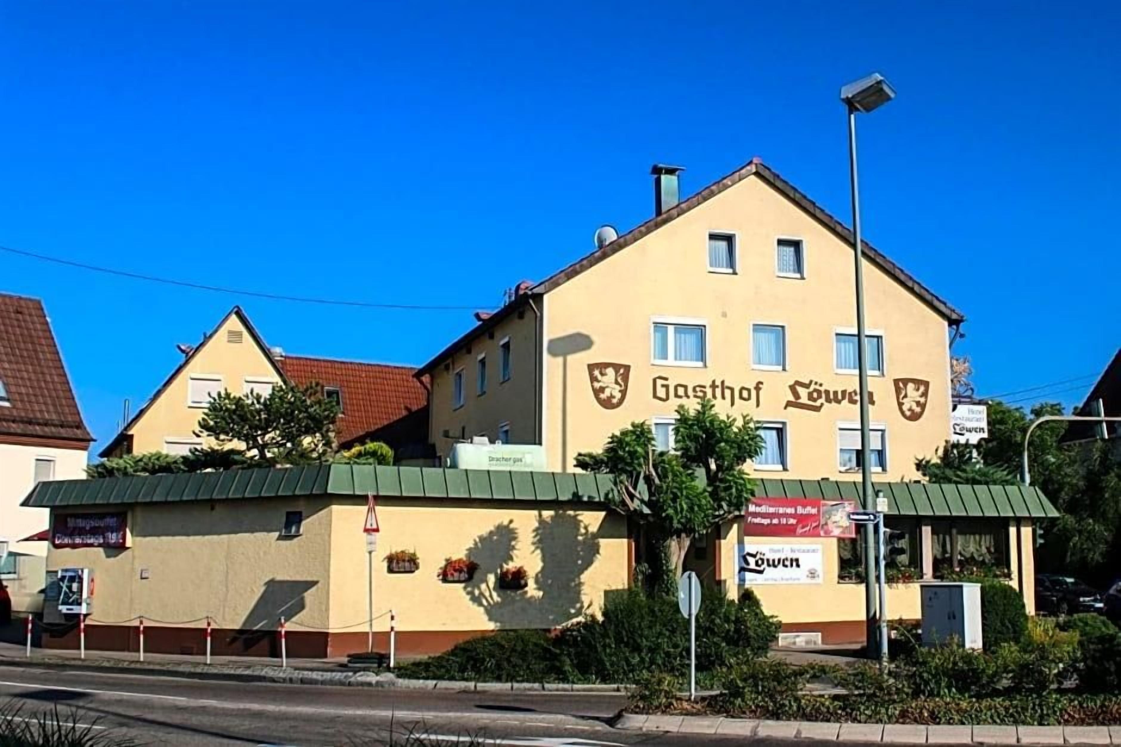 A building with a sign reading 'Gasthof Löwen' and a 'Mediterranean Buffet' sign.