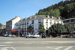 A hotel with a classic facade, multiple windows, and a sign indicating it is a hotel.