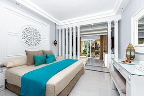 A modern hotel room with a large bed, a glass partition, and a view of the outside. - Grand Palace Adults Only 18 Years Plus (Hurghada)