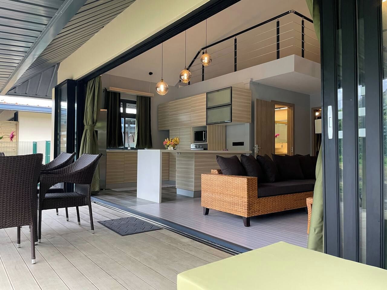 A modern interior with a dining area, kitchen, and seating space.