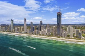 A coastal cityscape with high-rise buildings and a beach. - Paradise Coast Luxe in the heart of Surfers Paradise (Surfers Paradise)